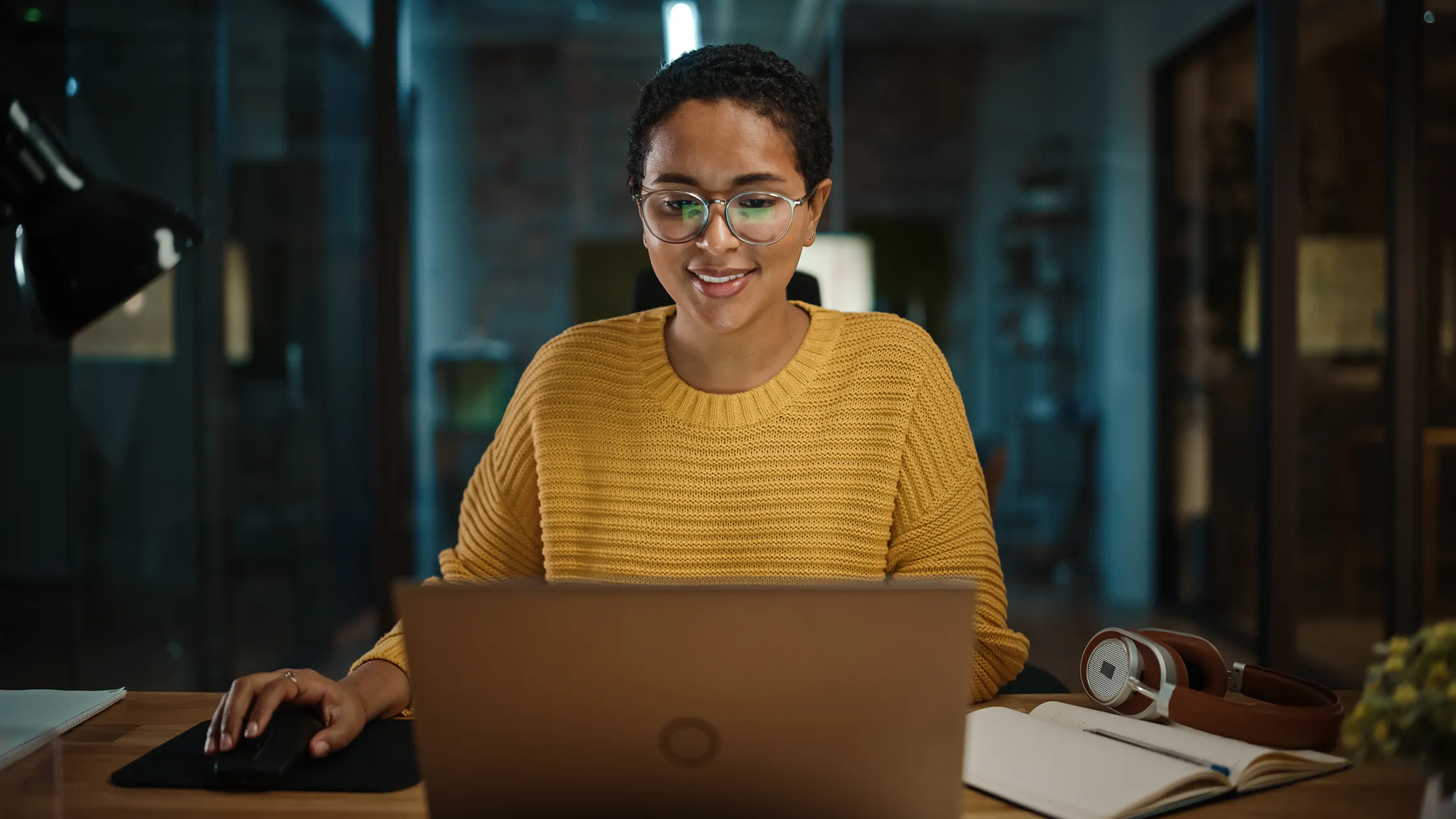 Professional working on a laptop in a modern office environment, showcasing innovation and digital design.