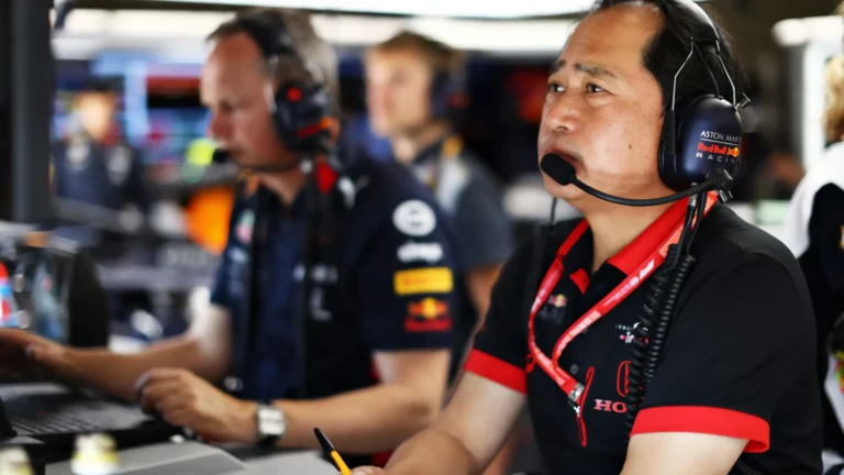 Red Bull Racing engineers working in the pit during a Formula 1 race.