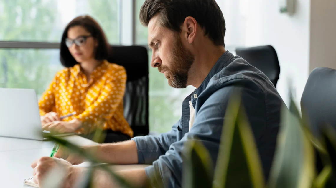 Schroders financial advisors discussing investment strategies in a modern workplace environment