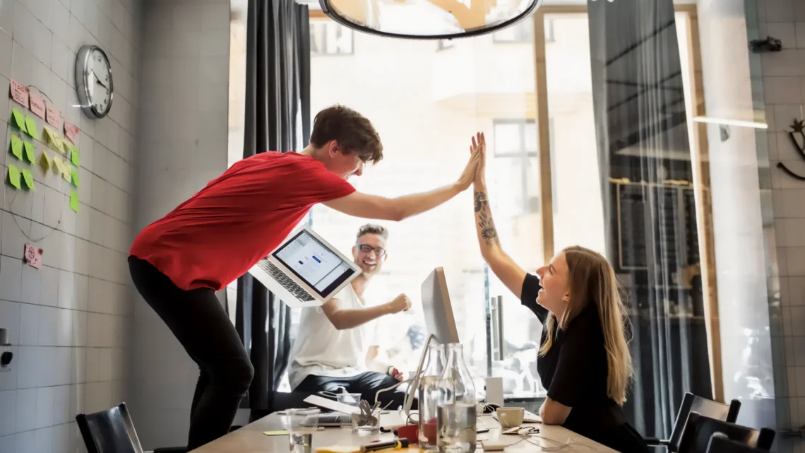 Team celebrating the successful milestone of Vodafone UK Ecommerce platform redesign.