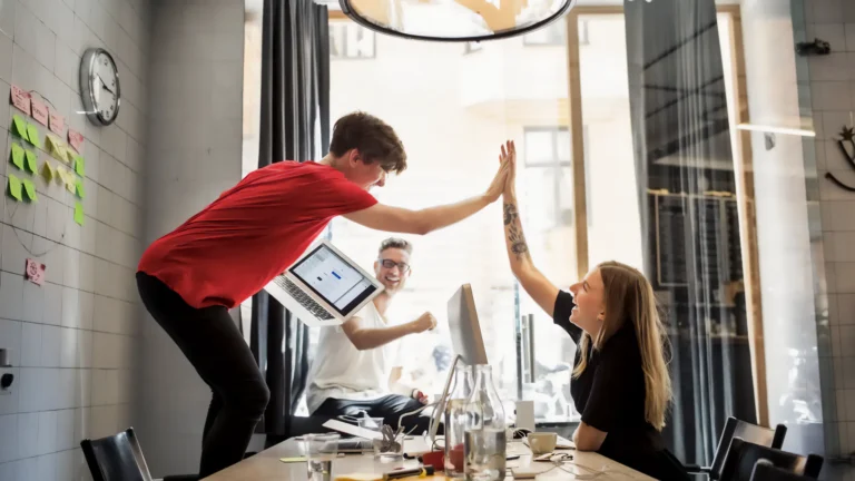 Team celebrating the successful milestone of Vodafone UK Ecommerce platform redesign.